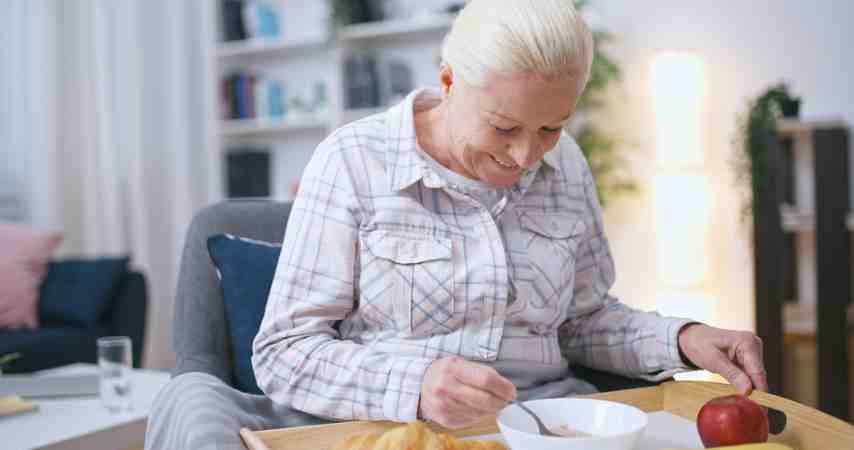 Elderly person eating nutritious breakfast